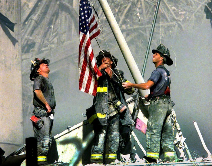 Firefighters raise the American flag on the ruins on the World Trade Centers [2001] Source: Thomas Franklin