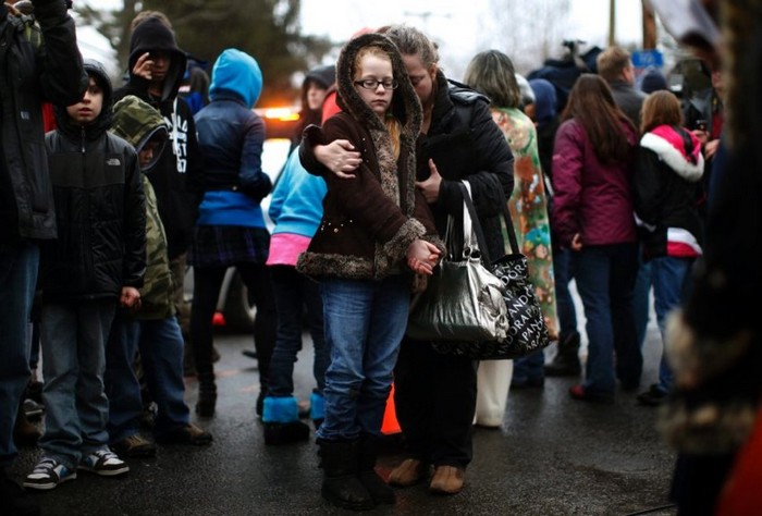  A mother comforts her daughter after the Sandy Hook shootings [2012] Source: Reuters