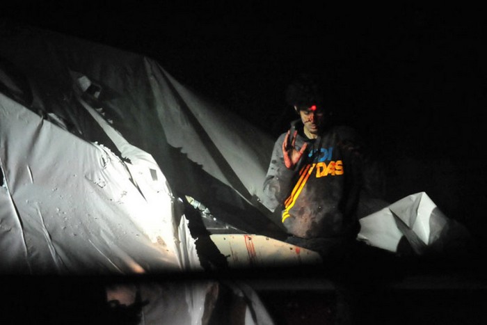  Dzhokar Tsarnaev, one of the brothers behind the Boston Marathon bombing, on the boat where he was eventually caught, with sniper lasers on his forehead. [2013] Source: Unknown Photographer
