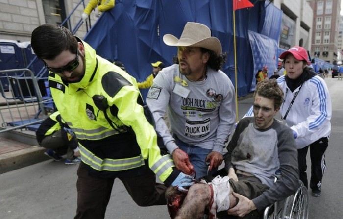  Carlos Arredondo helps Jeff Bauman after the Boston Marathon bombings. The two are now best friends. [2013] Source: AP